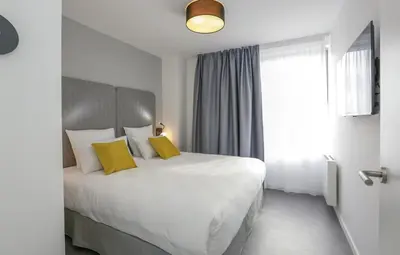Un ou plusieurs lits dans un hébergement de l'établissement Appart'hôtel Odalys City - Angers Centre Gare
