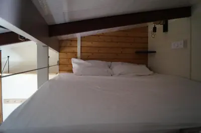 Un ou plusieurs lits dans un hébergement de l'établissement Bain Nordique SPA - Tiny house à la campagne