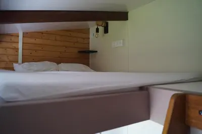 Un ou plusieurs lits dans un hébergement de l'établissement Bain Nordique SPA - Tiny house à la campagne