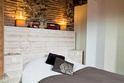 Un ou plusieurs lits dans un hébergement de l'établissement Loft charmant dans le centre historique