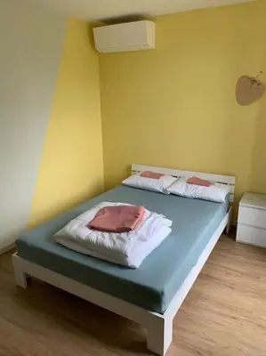 Un ou plusieurs lits dans un hébergement de l'établissement Appartement Torii - Maulévrier Cholet Puy du Fou