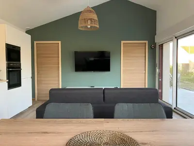 Télévision ou salle de divertissement dans l'établissement L’Oasis