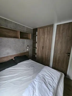 Un ou plusieurs lits dans un hébergement de l'établissement Jolie Mobil home 103