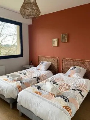 Un ou plusieurs lits dans un hébergement de l'établissement L'Échappée Belle - Appartement charmant et chaleureux