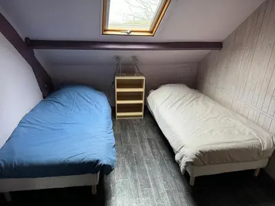 Un ou plusieurs lits dans un hébergement de l'établissement Gîte de la Haie des Bois - 8P