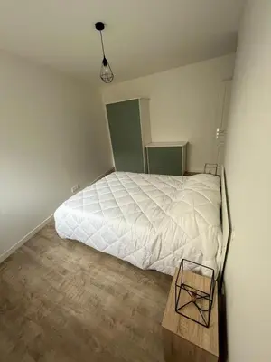 Un ou plusieurs lits dans un hébergement de l'établissement Appartement neuf avec patio
