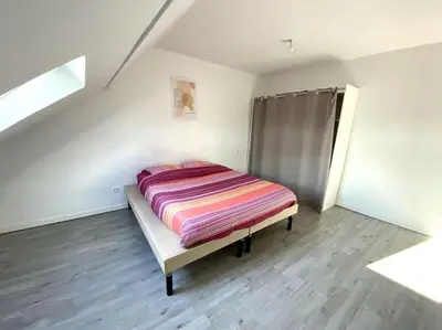 Un ou plusieurs lits dans un hébergement de l'établissement Appartement 2chambres/PuyDuFou