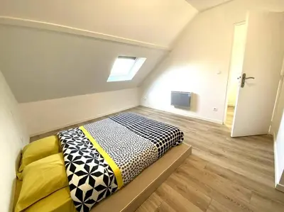 Un ou plusieurs lits dans un hébergement de l'établissement Appartement 2chambres/PuyDuFou