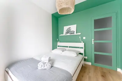 Un ou plusieurs lits dans un hébergement de l'établissement Le Rex - Bel appt avec sauna