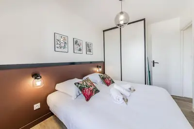 Un ou plusieurs lits dans un hébergement de l'établissement L'Azur chaleureux et cocooning