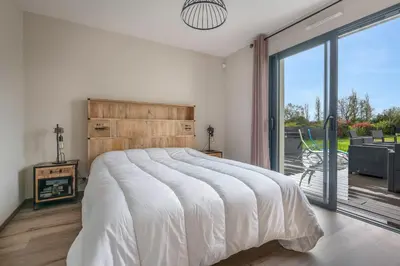 Un ou plusieurs lits dans un hébergement de l'établissement Maison familiale avec jacuzzi à Pornic