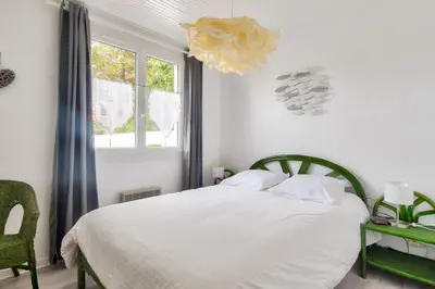 Un ou plusieurs lits dans un hébergement de l'établissement Escapade avec jardin à 5 min de la plage