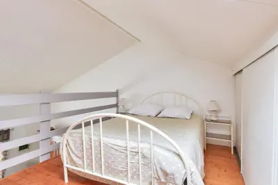 Un ou plusieurs lits dans un hébergement de l'établissement Escapade avec jardin à 5 min de la plage