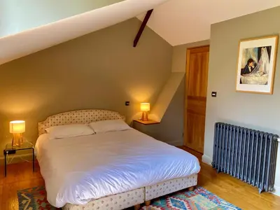 Un ou plusieurs lits dans un hébergement de l'établissement Maison avec jardin - L'Orangerie