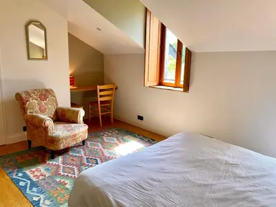 Un ou plusieurs lits dans un hébergement de l'établissement Maison avec jardin - L'Orangerie