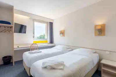 Un ou plusieurs lits dans un hébergement de l'établissement Hôtel La Petite Auberge