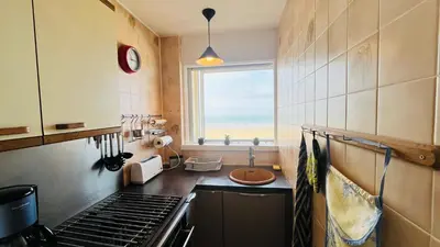 Cuisine ou kitchenette dans l'établissement Appartement sable et océan