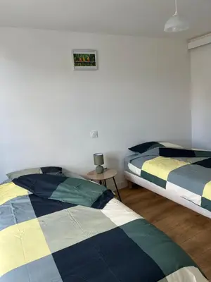 Un ou plusieurs lits dans un hébergement de l'établissement L'appartement des Perroquets