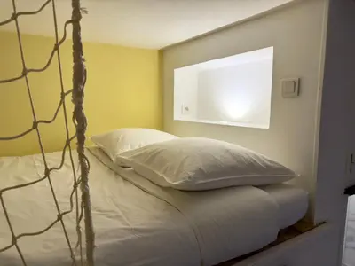 Un ou plusieurs lits dans un hébergement de l'établissement Studio cosy, proche gare