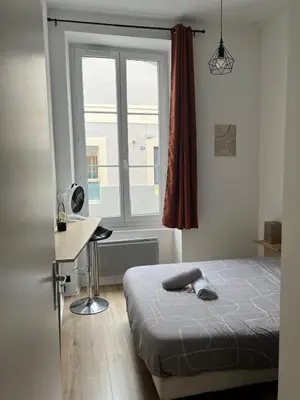 Un ou plusieurs lits dans un hébergement de l'établissement Charmant 2 chambres - Centre