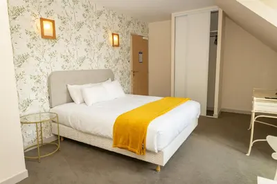 Un ou plusieurs lits dans un hébergement de l'établissement Auberge le Prieuré des Gourmands