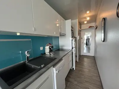 Cuisine ou kitchenette dans l'établissement L Arc en Ciel