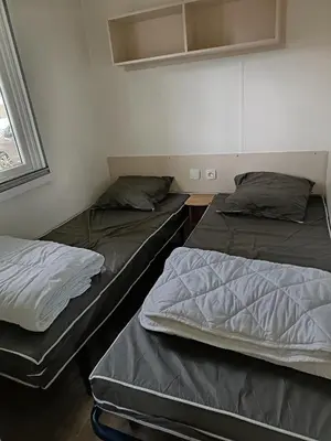 Un ou plusieurs lits dans un hébergement de l'établissement MH F52 Camping Bois Masson