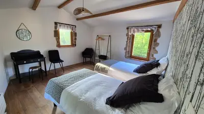 Un ou plusieurs lits dans un hébergement de l'établissement Le Cottage de Jousseaume