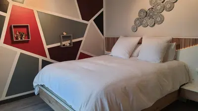 Un ou plusieurs lits dans un hébergement de l'établissement Les Chambres des 4 Vents - Chambres doubles à l'étage