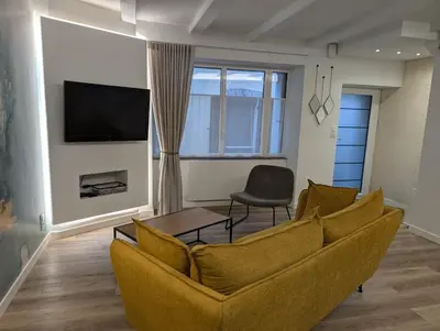 Télévision ou salle de divertissement dans l'établissement Maison chaleureuse au cœur du centre ville