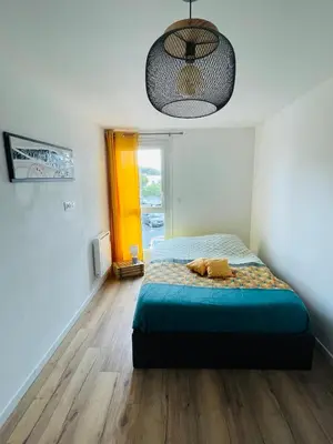 Un ou plusieurs lits dans un hébergement de l'établissement Bel Appartement proche des plages et commerces