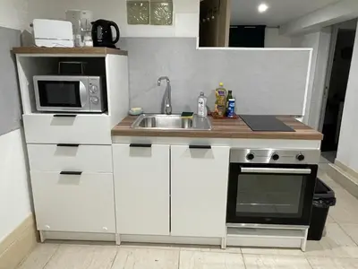 Cuisine ou kitchenette dans l'établissement Grande chambre, Sdb partagée