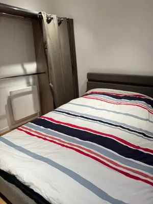 Un ou plusieurs lits dans un hébergement de l'établissement Appartement RDC vu sur jardin appart C