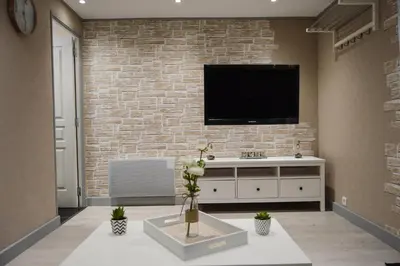 Télévision ou salle de divertissement dans l'établissement Au domaine de la maisonnette