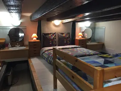 Un ou plusieurs lits dans un hébergement de l'établissement Cosy loft au coeur de Nantes centre ville