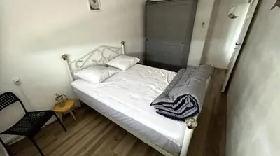 Un ou plusieurs lits dans un hébergement de l'établissement appartement au bord de l'océan