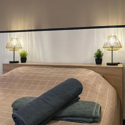 Un ou plusieurs lits dans un hébergement de l'établissement T2 paisible avec balcon verdoyant
