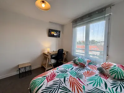 Un ou plusieurs lits dans un hébergement de l'établissement Appartement Cosy dans le Centre
