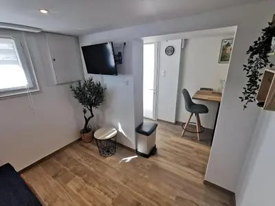 Télévision ou salle de divertissement dans l'établissement Studio aux portes du Puy duFou