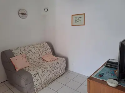 Télévision ou salle de divertissement dans l'établissement Location vacances