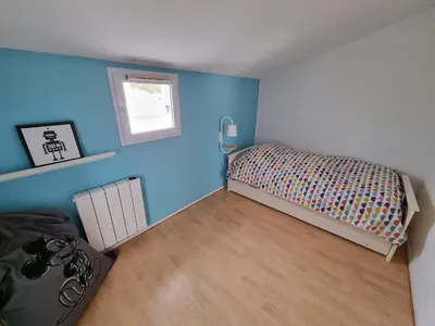 Un ou plusieurs lits dans un hébergement de l'établissement Maison bord de plage