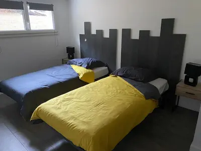 Un ou plusieurs lits dans un hébergement de l'établissement Maison spacieuse et agréable à 200m de la mer