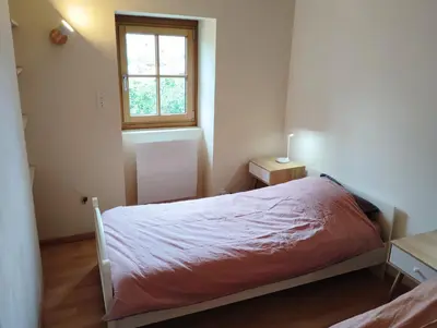 Un ou plusieurs lits dans un hébergement de l'établissement Gîte de l'Église de la Pommeraie
