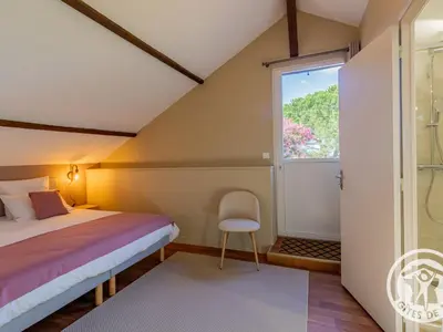 Un ou plusieurs lits dans un hébergement de l'établissement Gîte spacieux de 8 chambres au cœur des vignes d'Anjou - FR-1-622-112