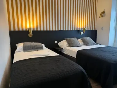 Un ou plusieurs lits dans un hébergement de l'établissement Arcades Hôtel - Cholet
