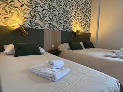 Un ou plusieurs lits dans un hébergement de l'établissement Arcades Hôtel - Cholet