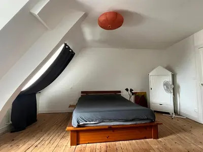 Un ou plusieurs lits dans un hébergement de l'établissement Appartements des Halles - Chambres d'Hôtes