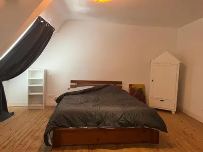 Un ou plusieurs lits dans un hébergement de l'établissement Appartements des Halles - Chambres d'Hôtes