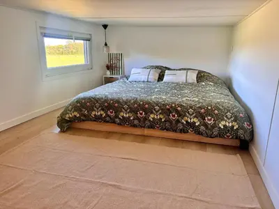 Un ou plusieurs lits dans un hébergement de l'établissement Tiny House cosy