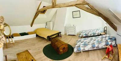 Un ou plusieurs lits dans un hébergement de l'établissement Appartement dans maison avec jardin privatif